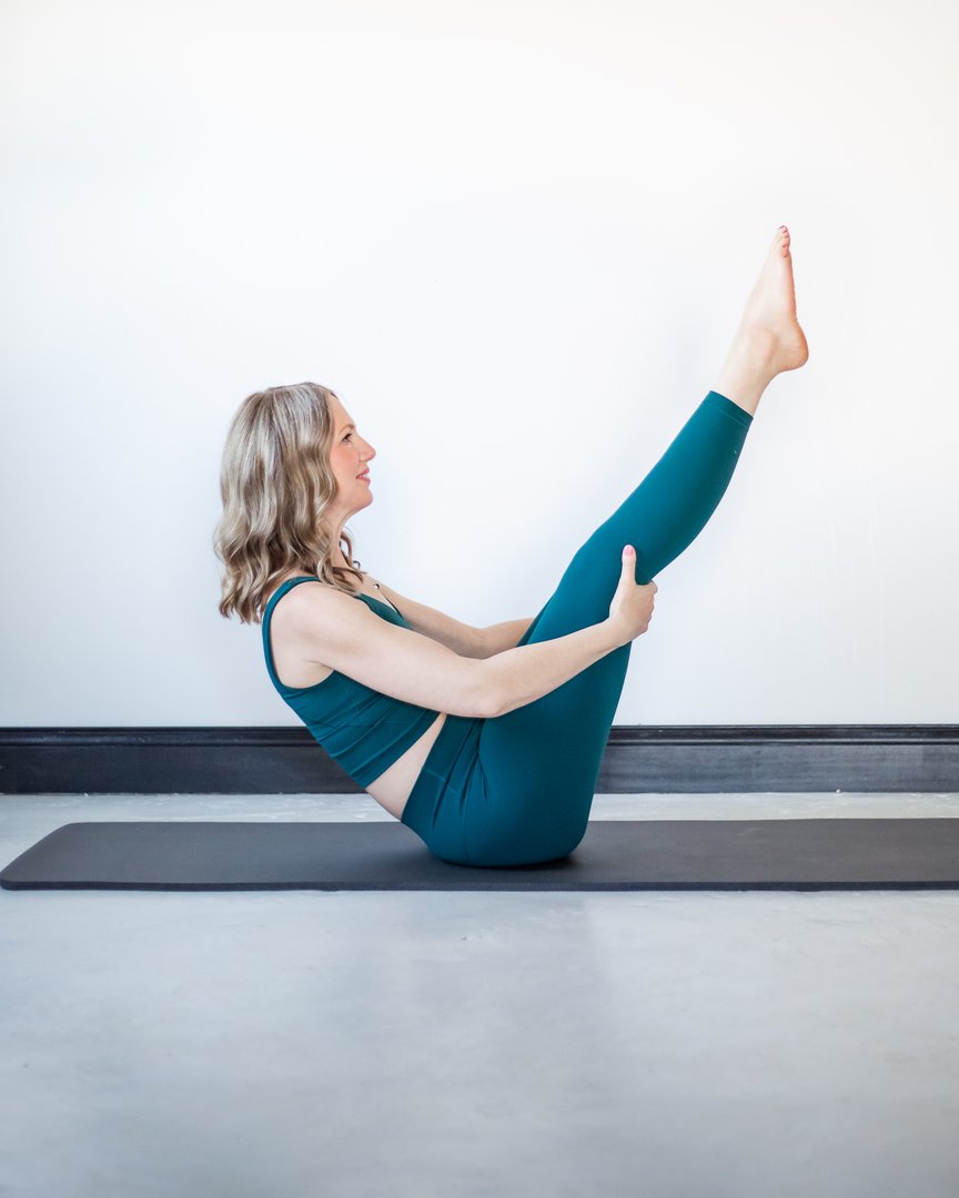 Tabitha Green in a Pilates teaser on a mat
